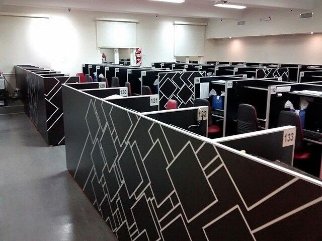 Rows of numbered call-centre cubicles in an open-plan office